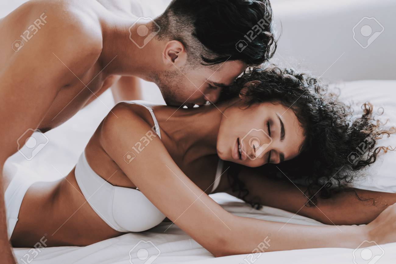 109792810-young-beautiful-couple-in-underwear-lying-on-bed-handsome-man-kissing-attractive-woman-passionate.jpg