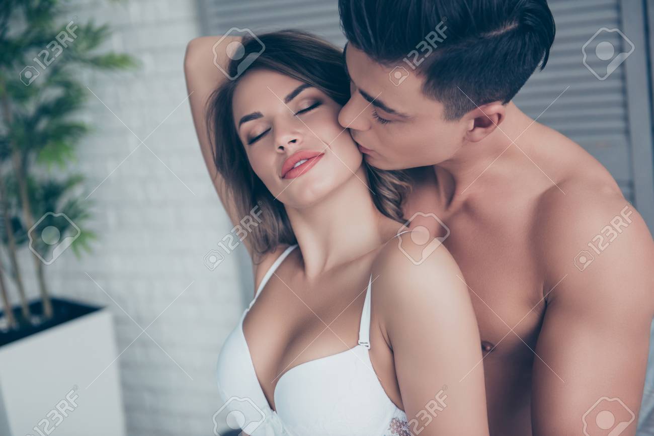 92491023-close-up-of-beautiful-half-couple-is-embracing-in-the-bed-room-man-kissing-his-lover-in-cheek.jpg