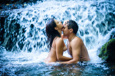 39441648-couple-hugging-and-kissing-under-waterfall.jpg