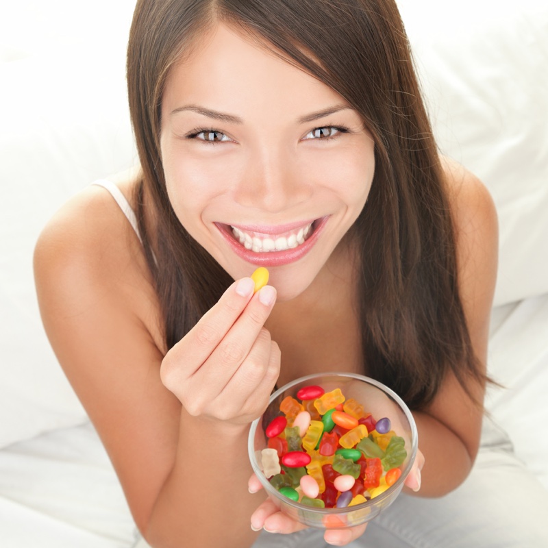Woman-Smiling-Eating-Gummies-Candy.jpg