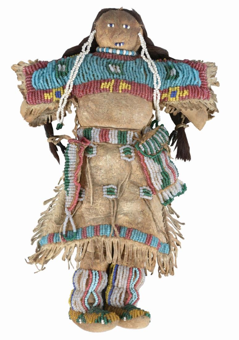 Doll Circa 1880's, made of Indian tanned buckskin and human hair. Entirely sinew sewn fringed dress with buffalo hair,1.jpg