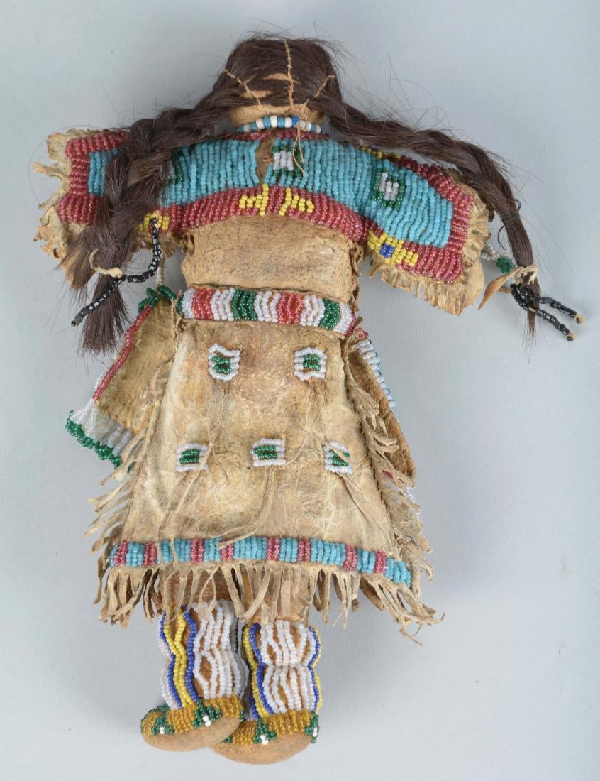 Doll Circa 1880's, made of Indian tanned buckskin and human hair. Entirely sinew sewn fringed dress with buffalo hair,4.jpg