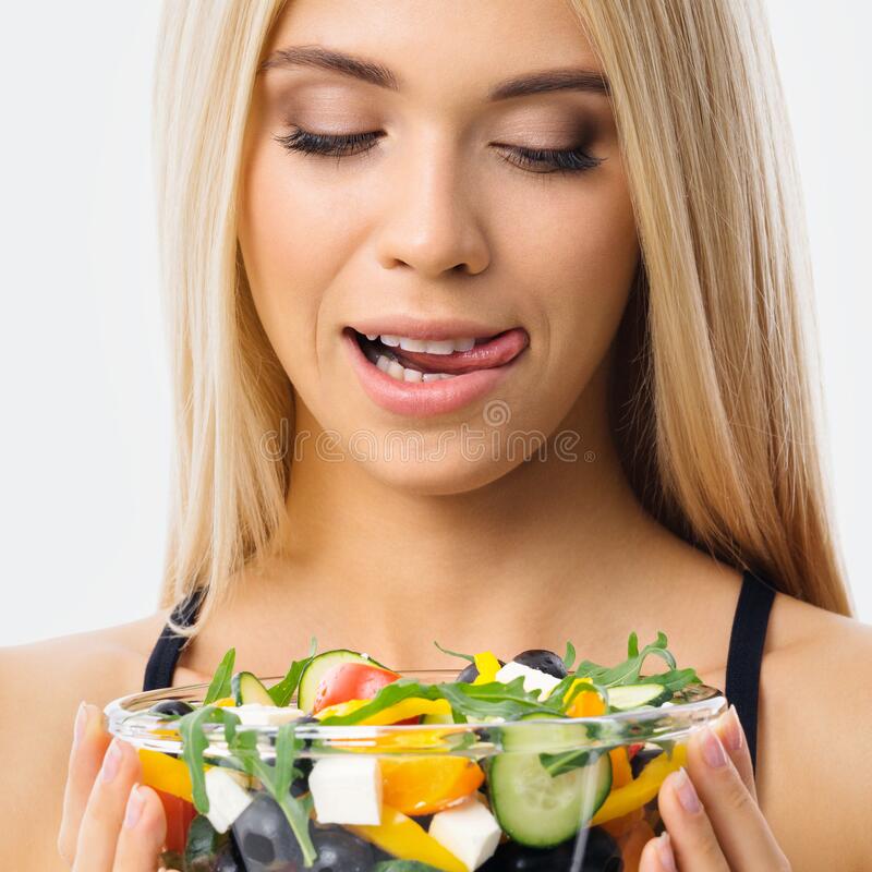 image-blond-woman-tongue-lick-mouth-looking-glass-plate-greece-salad-blonde-girl-studio-keto-diet-ketogenic-weigh-224424187.jpg
