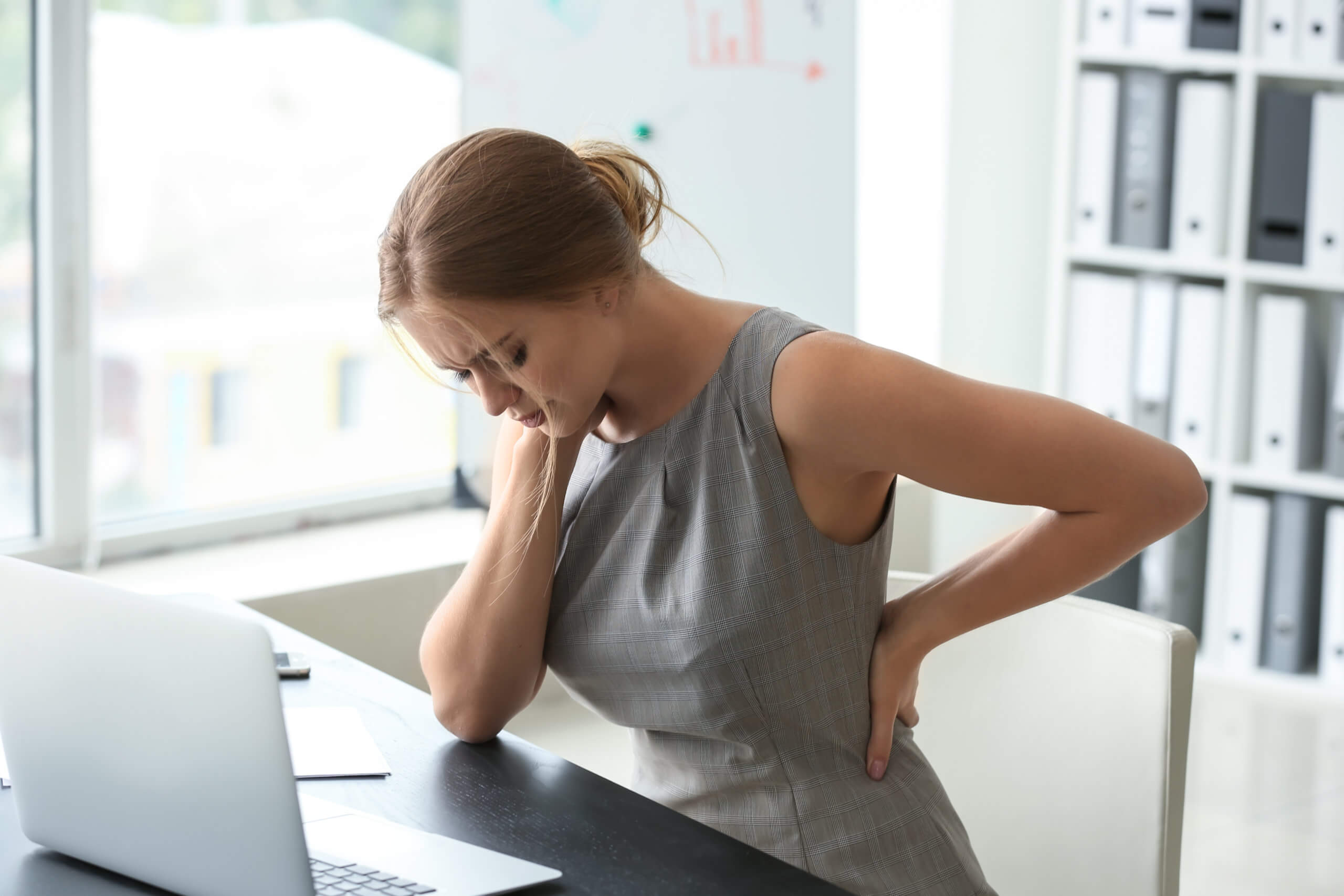 Woman-at-desk-in-pain-scaled-1.jpeg