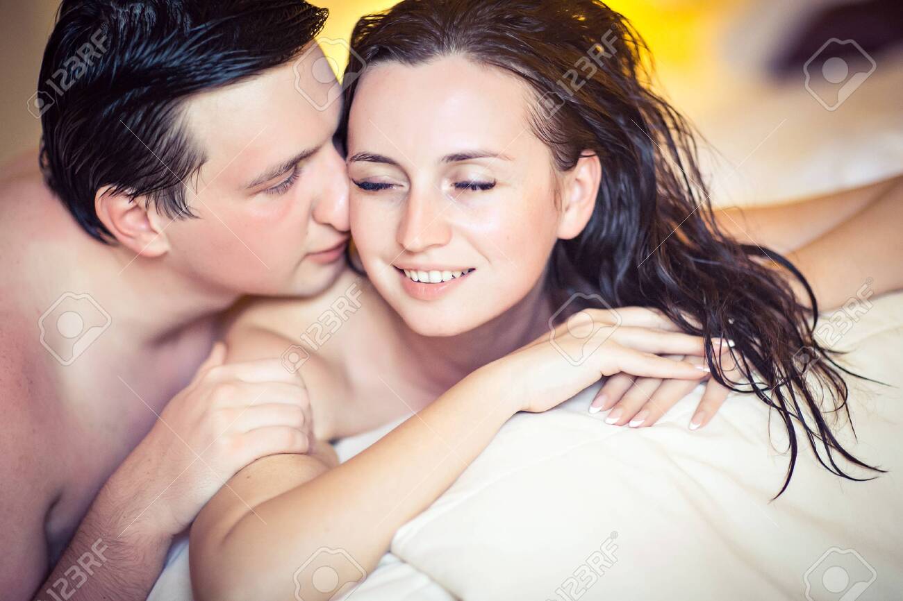 152611689-the-couple-after-a-shower-hugging-in-bed-romantic-relationship.jpg