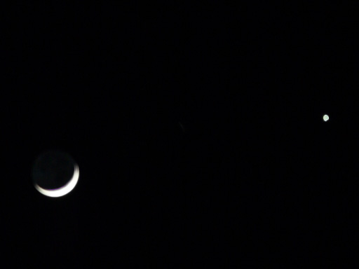 Photo of the
                            crescent moon and Venus near each other in
                            the dark sky