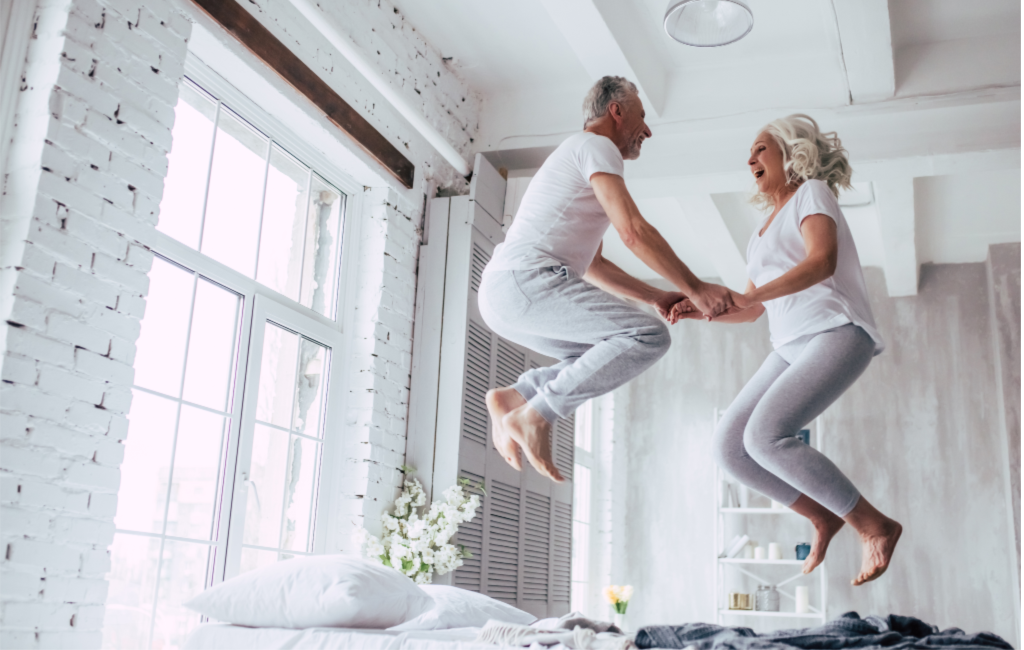 Senior_couple_jumping_on_bed_1024x.png