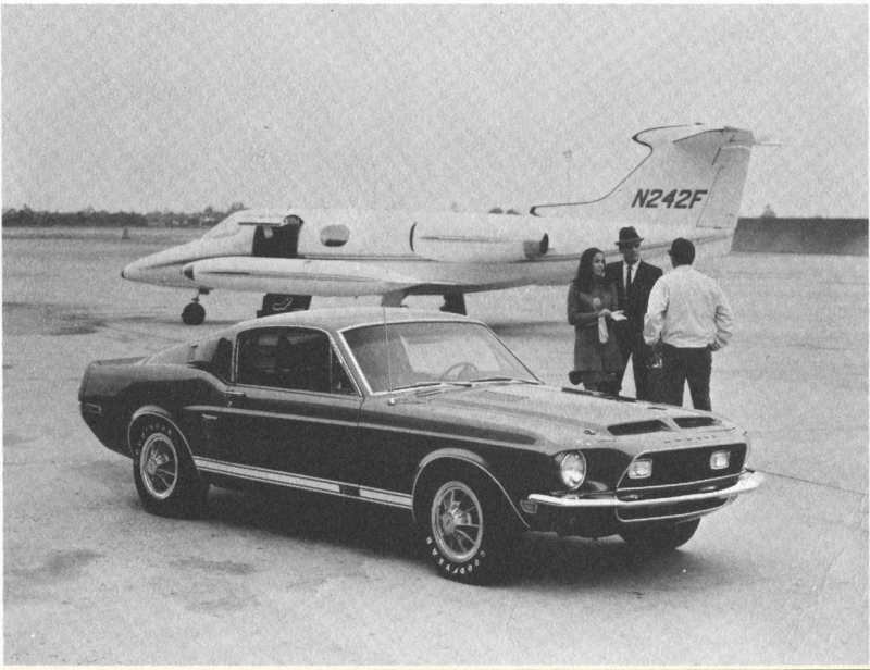 Blue Fastback in Front of Corporate Jet.png