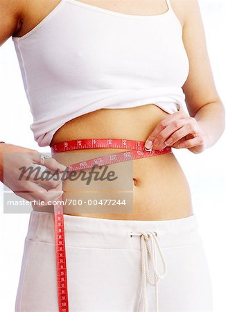 700-00477244em-woman-measuring-waist-with-measuring-tape-stock-photo.jpg