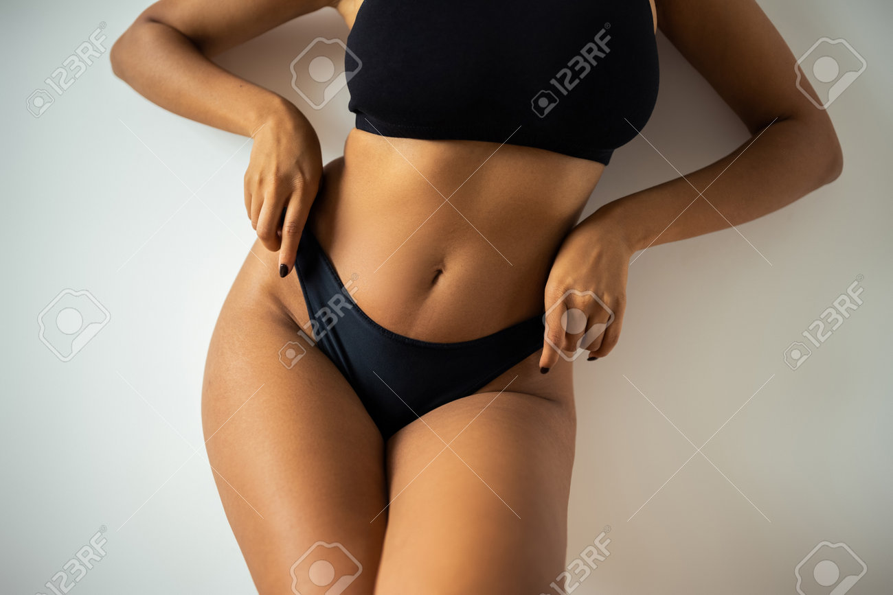 193796893-cropped-view-of-african-american-woman-in-crop-top-touching-black-panties-near-wall-at-home.jpg