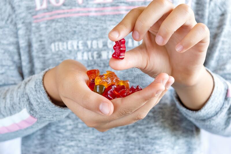 girl-holds-gummy-bear-her-hand-wants-to-eat-jelly-sweets-close-up-concept-children-s-delicacy-unhealthy-food-vitamins-230818813.jpg